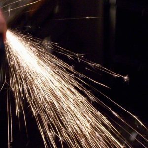 Photo of sparks made by grinding tool steel