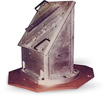 Photograph of a metal part welded to a base plate