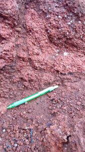 Photograph of light red rocks.